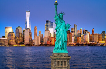 New York City skyline with the Statue of Liberty over Hudson River. Manhattan at dusk with Statue of Liberty. NYC iconic landmark with Statue of Liberty. © Volodymyr