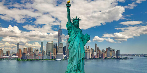 Fototapeta premium Liberty monument. New York City skyline. Liberty statue with NYC skyline. New York City banner with Liberty monument. Liberty statue and New York City skyscrapers.