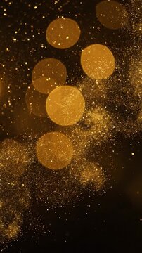 Golden bokeh lights and sparkling particles on a dark background