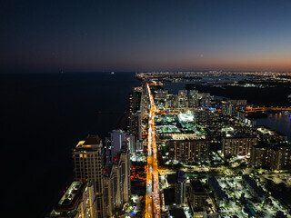 Obraz premium Aerial night view of Miami skyline and Biscayne Bay with city lights, Florida USA