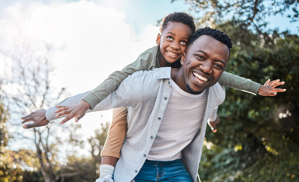 Portrait, smile and father with boy on shoulder, bonding together and playing with nature. Outdoor, black family and dad carrying kid, happiness and game for fun, love and flying with weekend break
