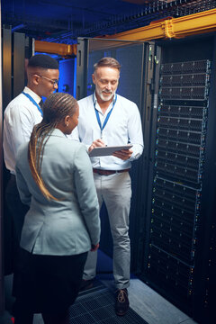 Cybersecurity, storage and tablet with people in server room together for problem solving or solution. App, collaboration and conversation with team in data center for engineering or IT support