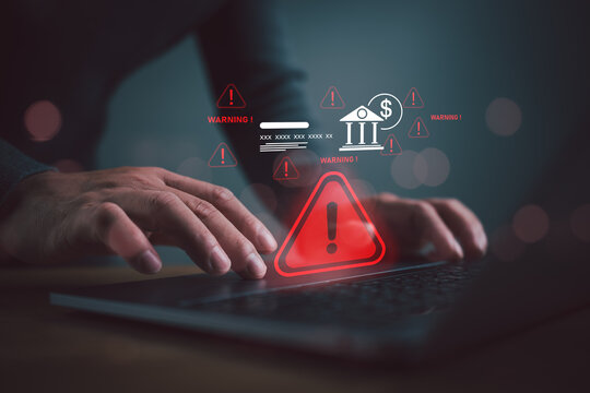 Cybersecurity warning alert for online banking fraud and financial risk detection on laptop with digital threat notification and secure transaction monitoring.