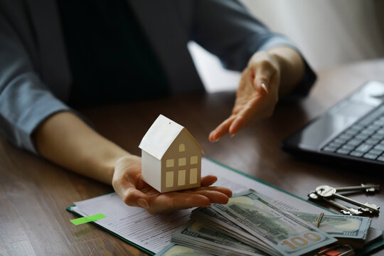 Real estate agent talked the terms of the home purchase agreement and asked the customer to sign the documents, Home sales and insurance concept.
