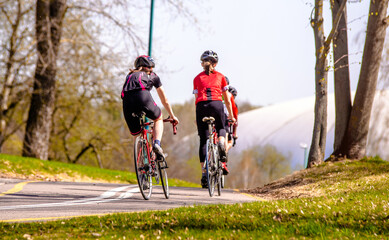 Fototapeta premium Cyclists ride on the bike path in the city Park 