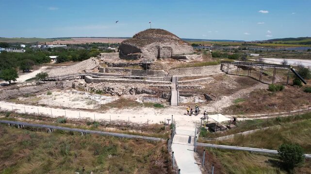Aerial view of Solnitsata prehistoric salt town with ancient stone walls and wooden walkways under a clear sky in Provadia, Varna, Bulgaria.