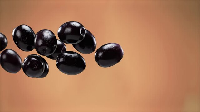 A group of ripe, shiny black olives suspended in mid-air against a soft terracotta or brown backdrop. Ideal for Mediterranean cuisine videos, olive oil branding, or organic food advertisements.