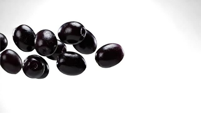 A handful of glossy, ripe black olives tumble, roll, and settle against a pure white studio backdrop. This clean macro asset is optimized for culinary videos, Mediterranean diet promotions, and organi