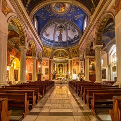 Fototapeta premium Grand interior of a cathedral with ornate ceiling and wooden pews