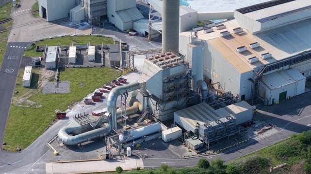 Aerial view of Guardian Glass Production Factory featuring large ventilation pipes, chimneys, and warehouse buildings in Goole, England, United Kingdom.