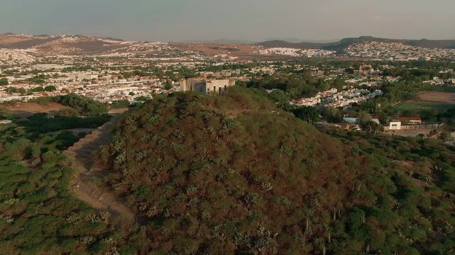 Aerial panoramic of El Cerrito hill pyramid ruins in Santiago de Queretaro, Mexico