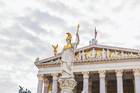  Pallas Athena Fountain in front of Austrian Parliament Building in Vienna, Austria, featuring statue of goddess Athena holding spear.