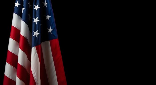 American flag hanging vertically against a black background, high contrast patriotic composition with copy space