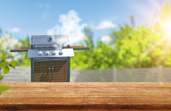 summer time in backyard garden with grill BBQ, wooden table, blurred background