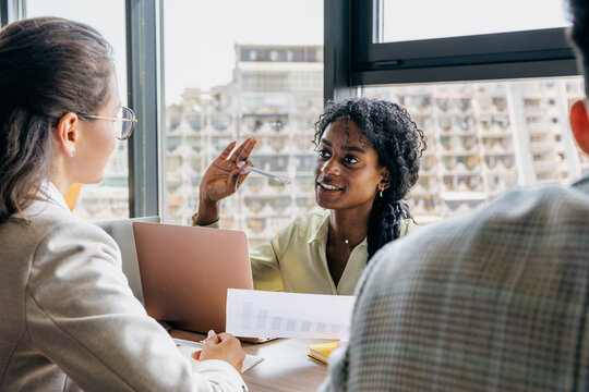 Lively team discussion taking place in modern city office setting