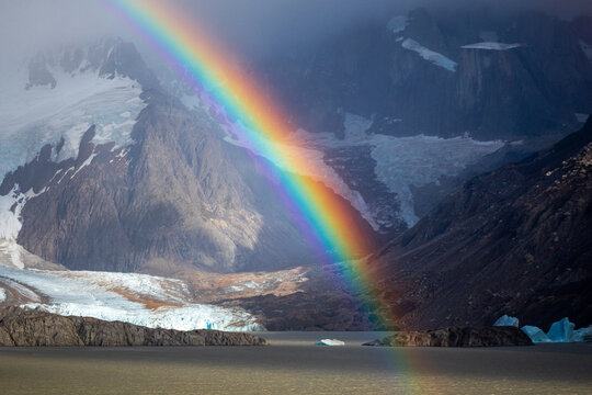 Rainbow over glacier lake and rugged mountains in Patagonia Argentina