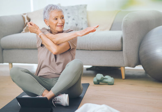 Pilates, old woman or stretching with tablet on mat in home for workout guide or online tutorial. Active, elderly or female person with arm warm up or technology for training tips or indoor exercise