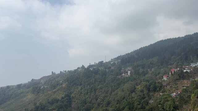 Scenic landscape view of lush green hills n misty mountains on the road to Darjeeling, West Bengal.