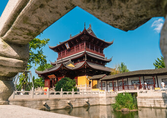 Fototapeta premium Ornate Chinese temple building and corridor over calm water