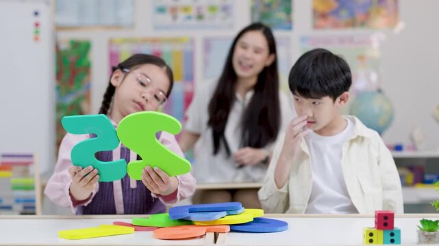 Thai Elementary Students Learning Math with Foam Numbers in Classroom