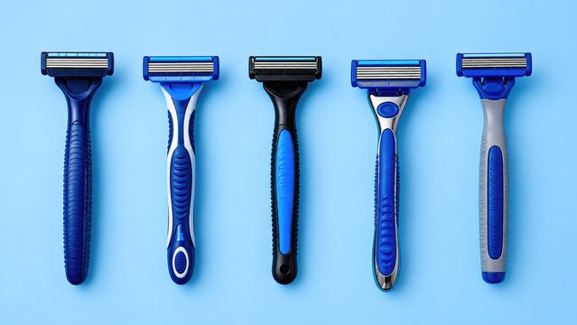 Collection of Disposable Razors on Blue Background Flat Lay