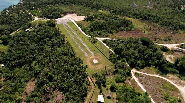 Aerial view of Cape Wom International Memorial Park featuring the memorial path surrounded by dense tropical greenery and coastal vegetation in Wewak, East Sepik Province, Papua New Guinea.