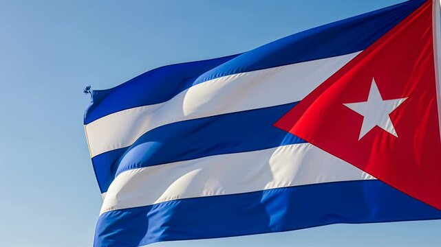 cuban flag waving over blue sky white stripes red triangle star