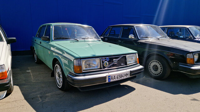 Kiev, Ukraine - May 3, 2026: Volvo 244 1976-1982 years of production. Open-air exhibition of retro cars. Classic green sedan. Row of vintage cars against a blue wall during a sunny day