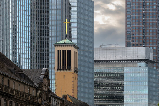 Construction scaffolding wraps a Frankfurt building facade during renovation where architecture shifts between modern and historic in an urban setting