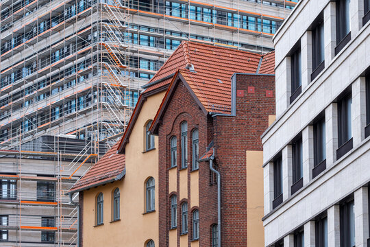 Urban Berlin street view with historic buildings beside modern architecture where facade lines shape a calm cityscape and wide sky backdrop