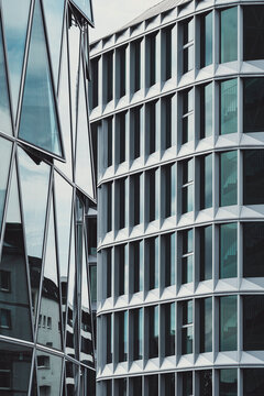 Reflection on glass facade in frankfurt shows geometric modern architecture of a financial office building framed by urban angles today