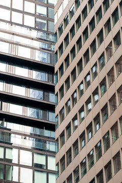 Abstract urban architecture in frankfurt featuring modern facade windows and a skybridge on a financial office skyscraper captured from below