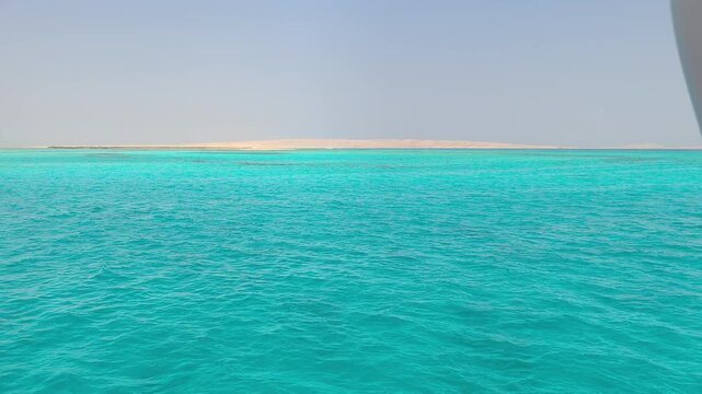 A view of the island, coral reef, and sandbar on a sunny, clear day at sea. An active lifestyle during vacations, holidays, and weekends. A boundless ocean of nature.