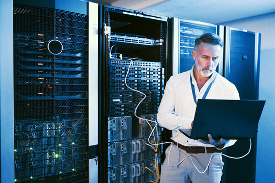 Server room, laptop or man with network cable for cyber security, system maintenance or inspection. Serious, data center or mature engineer with computer for IT, troubleshooting and database backup