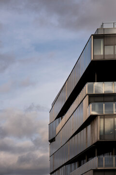 Moody clouds behind modern building facade and sky with copy space minimal urban exterior architecture glass lines for editorial design template