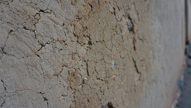 Close-up of earthen wall in traditional ethnic minority house in Vietnam, mud wall texture rustic construction detail vernacular architecture cultural heritage