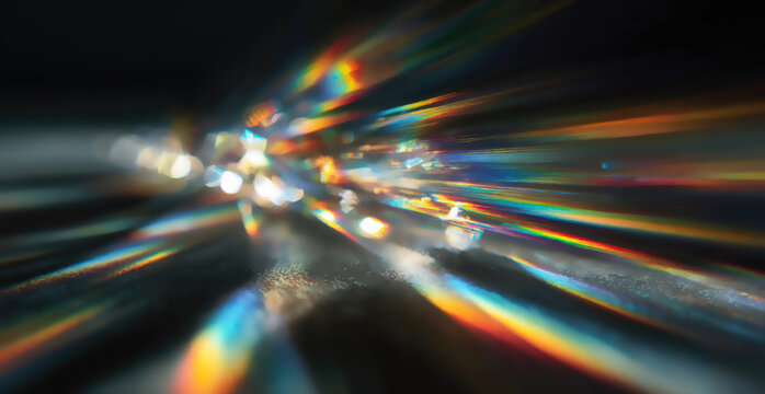 Dazzling prismatic light beams burst outwards from a bright focal point
