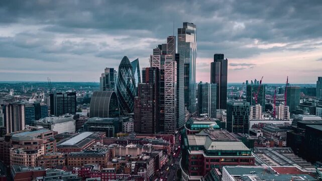Aerial hyper time lapse view of the modern skyline at the City of London, England, with dramatic cloudscape