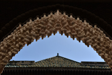 Naklejka premium Carved stone gate arch, carved wooden architectural details, Medersa bou Inania, Fez, Morocco