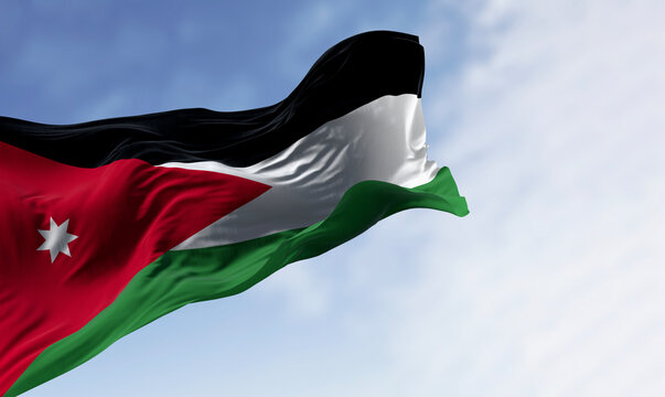 Jordan national flag waving in the wind. Black, white, and green horizontal stripes with a red chevron on the left housing a white seven-pointed star. 3d illustration render.