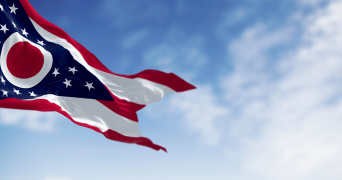 The Ohio state flag waving in the wind on a clear day. 3D illustration render. Rippled textile. Selective focus