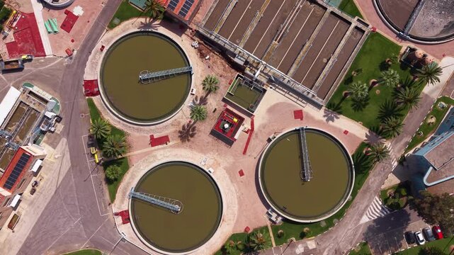 Overhead view of a modern water treatment plant featuring circular clarifiers, aeration basins and biological treatment tanks for nitrogen and phosphorus removal