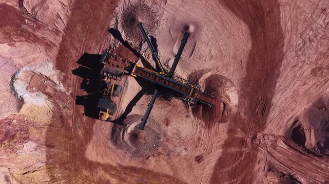 Overhead view of a multi-deck mobile screening plant with radial discharge conveyors separating clay and soil at an open-pit mining quarry