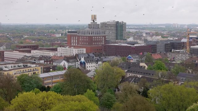 Aerial view of dortmund, germany, with the iconic dortmunder u building and birds flying