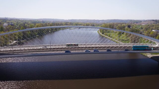 Aerial view of traffic jam on modern Troja Bridge with public transport tram and bus crossing Vltava river toward Hole&scaron;ovice district in Prague on a sunny day