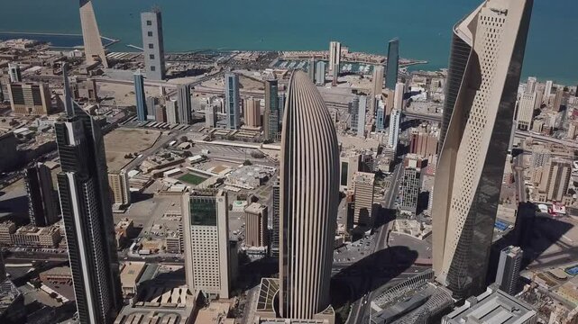 Drone view of downtown Kuwait City skyline with modern towers and the Arabian Gulf in the background