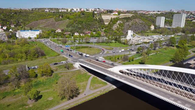 Aerial sunny view of road traffic and the Blanka tunnel entrance at a complex urban intersection in Prague-Troja district