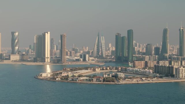 Modern architecture of manama city skyline with skyscrapers and waterfront on a hazy day