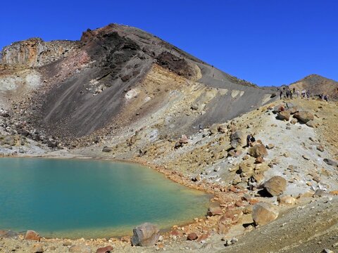 looking up at red crater from emerald lakes  on the tongariro alpine crossing descent  on the north island of new zealand, on a sunny summer day 