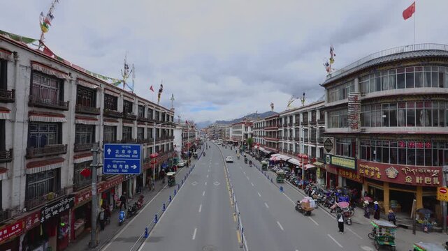Busy street with traffic and shops in Lhasa, Tibet